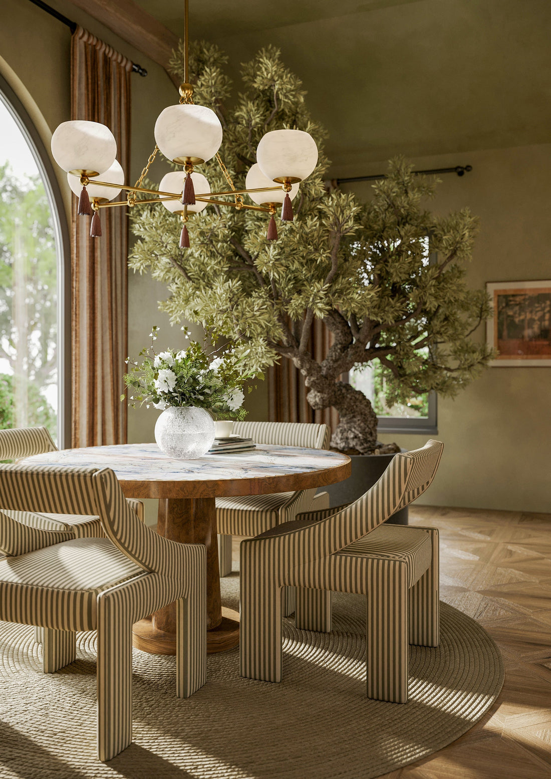 Elegant chandelier hanging in a modern dining room, providing warm ambient lighting.
