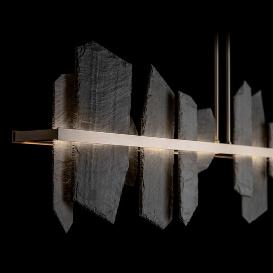 Up-close detail of the Ardesia Linear Pendant by Hubbardton Forge, showcasing hand-forged metalwork and natural slate accents