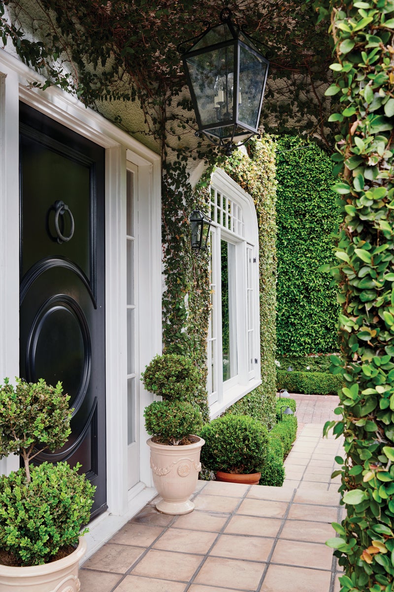Modern outdoor ceiling light fixture installed on a covered patio with warm ambient lighting.