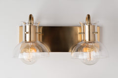 Mitzi Riley 2-Light Dimmable Vanity Light with Clear Glass Shades in Aged Brass or Polished Nickel