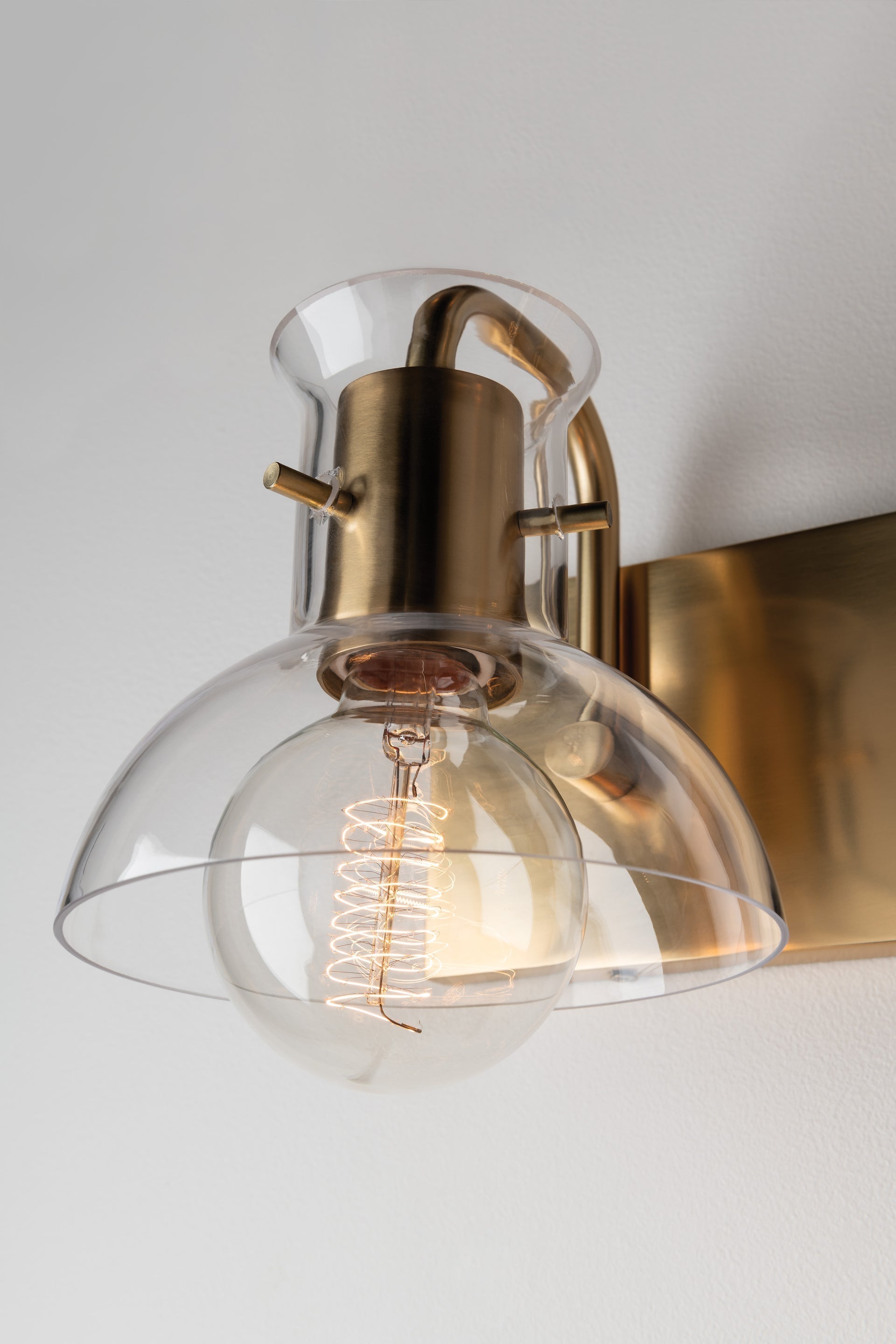 Mitzi Riley 2-Light Dimmable Vanity Light with Clear Glass Shades in Aged Brass or Polished Nickel